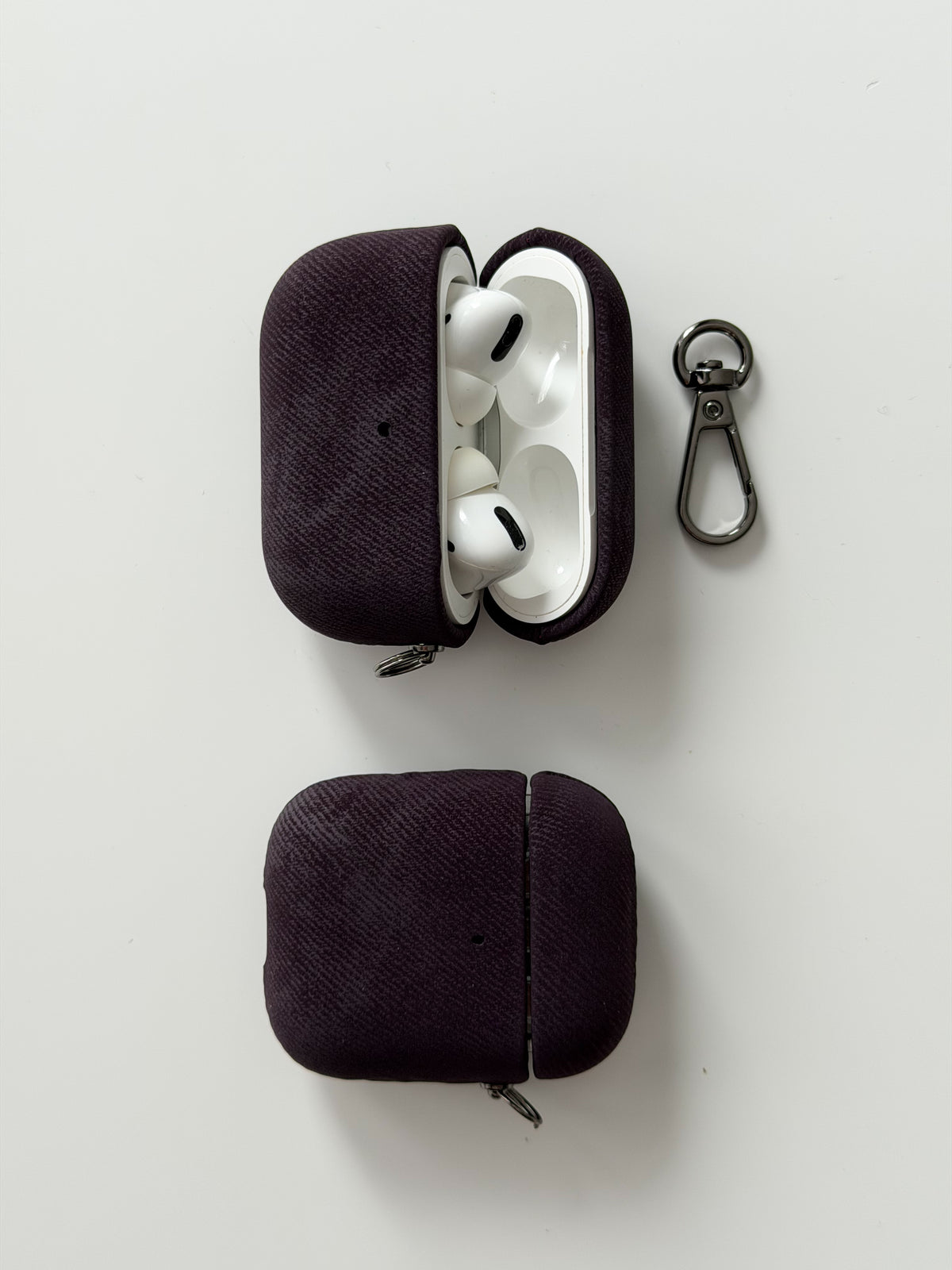 Два чохли «Замшева м’якість» для AirPods — відкритий із навушниками та закритий, поруч карабін