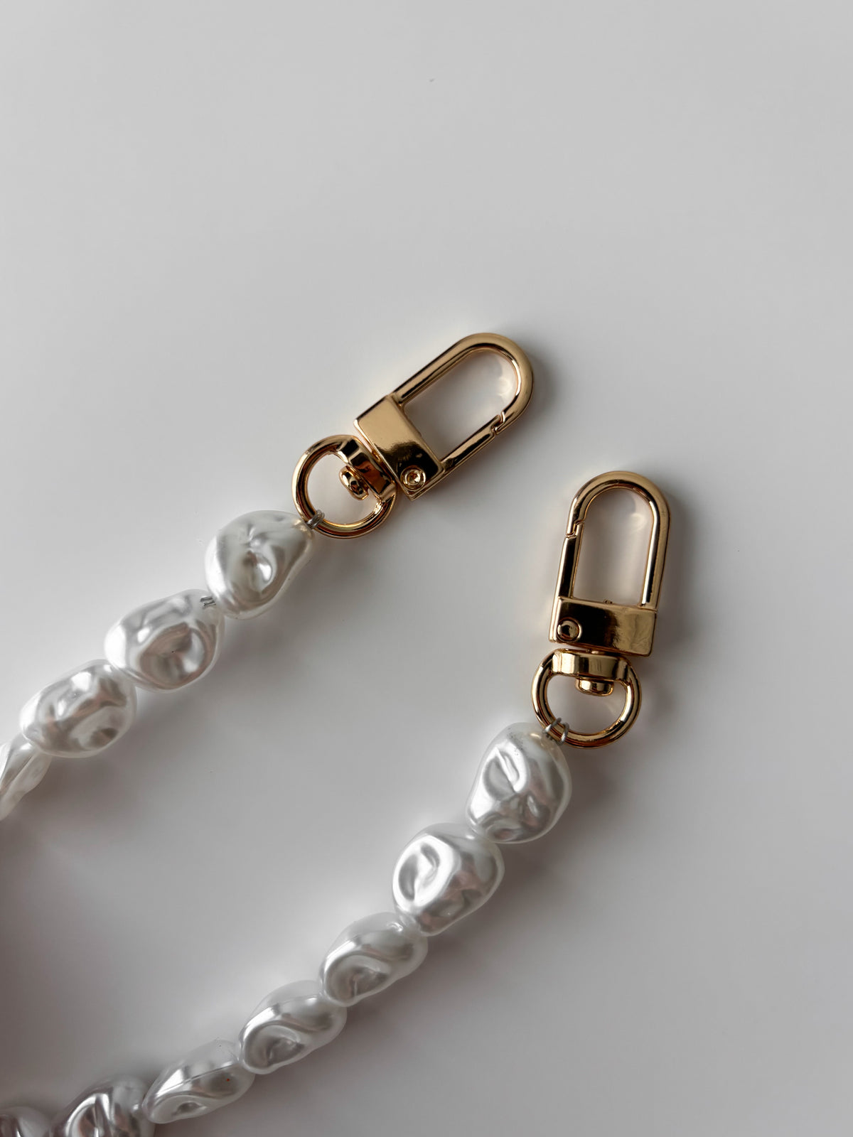 Ланцюжок Baroque Pearl — крупний план золотистих карабінів і намистин